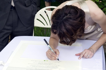 Bride Signs the Wedding Certificate