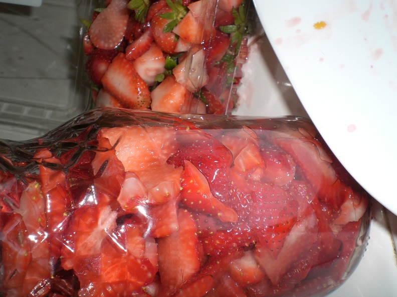 The cut up strawberries for Tequila por Mi Amante are in the jar. The discarded white parts, stems, bad ones, etc. are in the box behind. Two boxes were enough, although I had a very full box of discarded parts at the end. flickr-ginsnob-1047656661.jpg