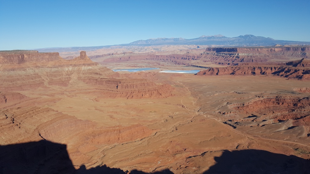 The bright blue is solar evaporating ponds mining salt. They flush water down into the earth to dissolve the salt, pump it back up into open fields and add blue dye to speed up the process.