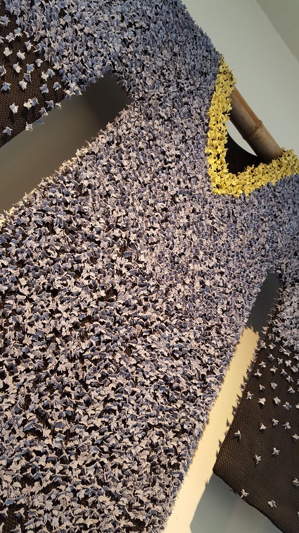 Dress decorated with a skin of ceramic butterflies